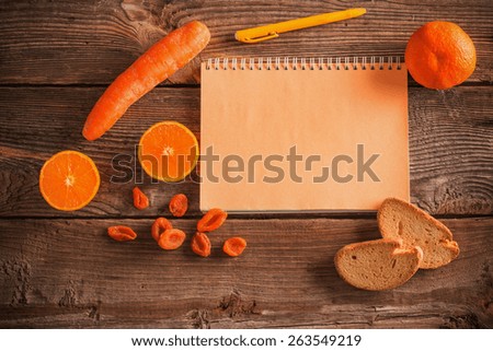 Orange fruits and vegetables on wooden background