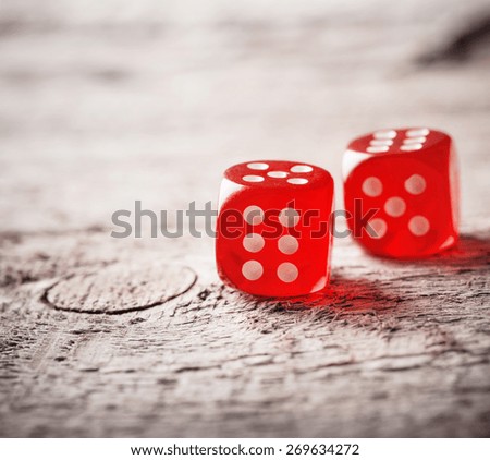 Pair of thrown red dices on old wooden table