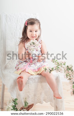 little girl with flowers indoor