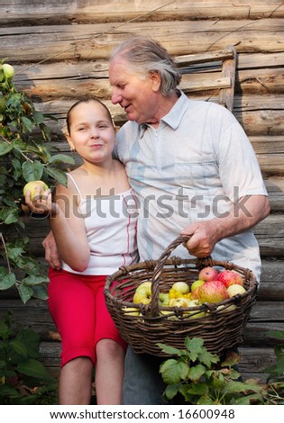 grandfather with girl in garden