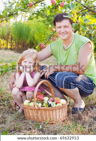 father with girl in garden