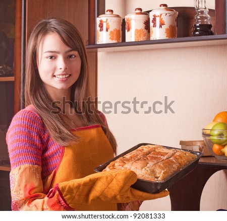 beautiful girl with cake in kitchen