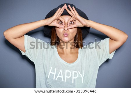 Ethnic woman making funny face with hands