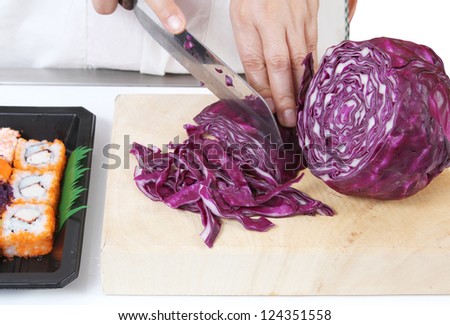 Closeup image of hand cutting vegetables for sushi japanese food