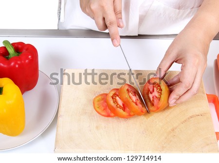 Image of woman cutting tomato and prepare vegetables food for dinner