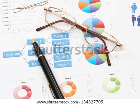 image of info graphics for business report with pen and calculator