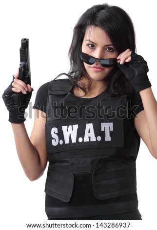 asian woman wearing swat bulletproof vest and holding a gun on her hand