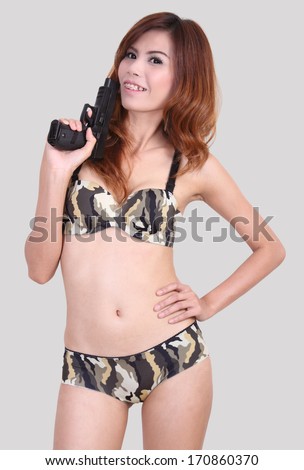 asian woman in sexy bikini holding a gun on her hand
