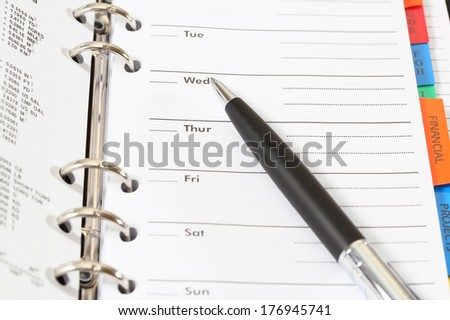 closeup image of pen and organizer book