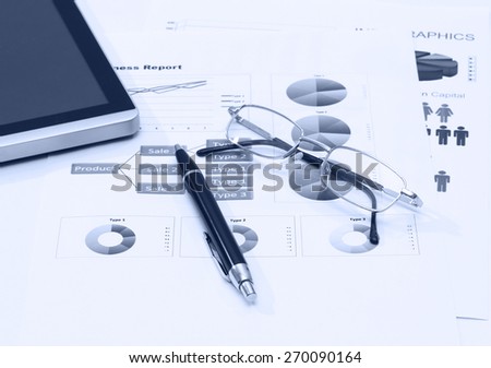 image of business report with pen tablet and glasses