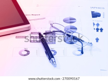 image of business report with pen tablet and glasses