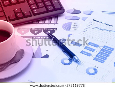 image of graphics for business report with pen black coffee and keyboard