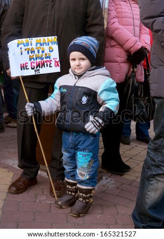 TERNOPOL, UKRAINE-DEC. 1: Ukrainian political action opposition \'\'Ukraine for European Integration\'\' poster: Mom and Dad on the Square do not beat them  in Ternopol, Ukraine on December 1, 2013.