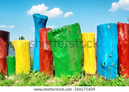 Rainbow-colored wood decoration in garden. Shot near Tyudiv, Carpathian Mountains, Ukraine.