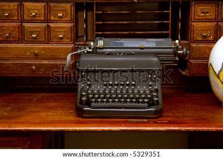 Old typing machine on red wood table. Shot in Stellenbosch, Western Cape, South Africa.