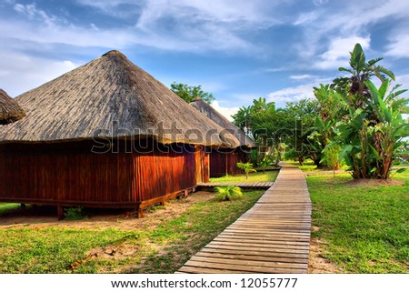 Wooden houses in tropical lodge park. Shot near Sodwana Bay nature reserve, KwaZulu-Natal province, Southern Mozambique area, South Africa.