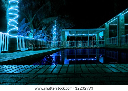 Night view at outdoor swimming pool next to restaurant. Shot in farm near Stellenbosch, Western Cape, South Africa.