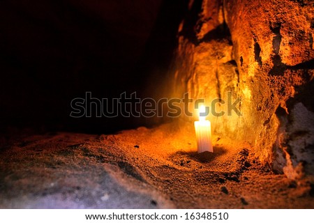 Candle in dark cave. Shot in Table Mountain Nature Park, near Cape Town, South Africa.