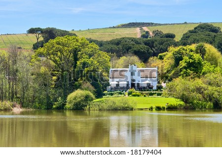 Big house next to lake and hills. Shot in Kuils River Winelands, near Stellenbosch/Cape Town, Western Cape, South Africa.