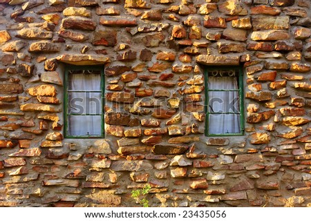 Window on rustic wall made from rocks - sunrise light. Shot in Gifberg Mountains, near Wanrhynsdorp, Western Cape, South Africa.