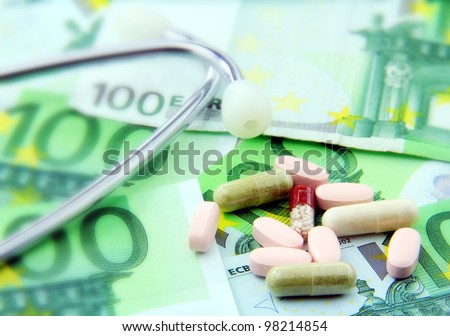 A concept of huge expenses on health care; paper money stethoscope and pills.