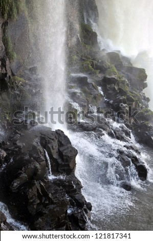 Water falling on rocks. Vertical image.