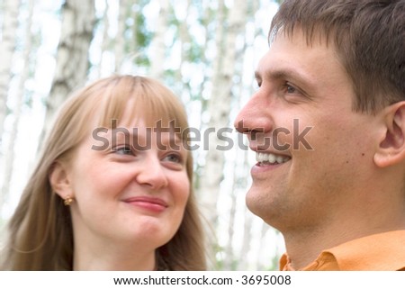 happy couple talking and laughing together. Soft-focused, focal point is on the man