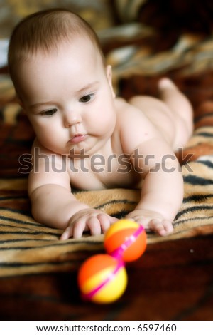 Baby with toy, very low DOF, natural light from window, iso 800, slightly noisy, focus in on face