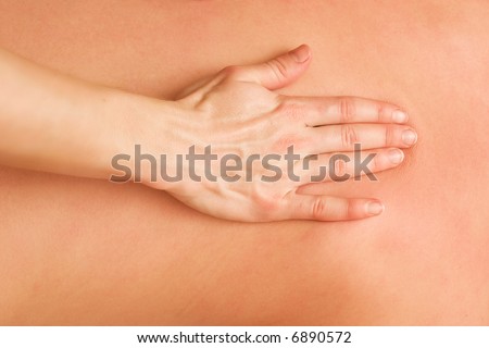 hand of massage specialist on the back of patient