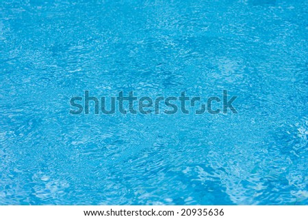 Surface of swimming pool with clean blue water