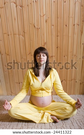 Pregnant woman relaxing on the floor in yoga meditation