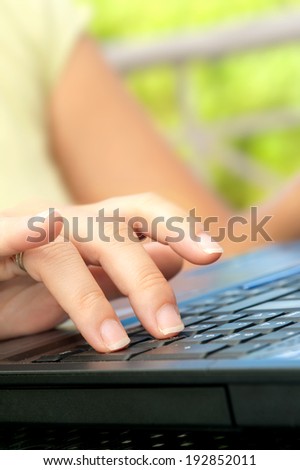 Female hand writing on laptop, close up