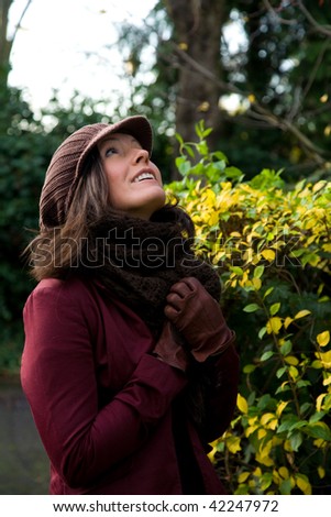 Woman goes for an autumn stroll in a park