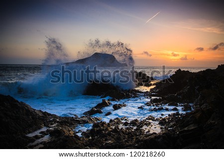 Wave spray at sunset by Worms Head in Wales