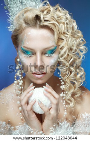 snow-queen. Young woman in creative image with silver blue artistic make-up and perfect hairstyle.