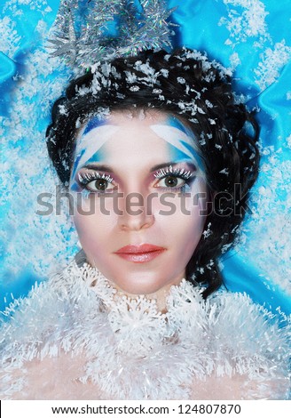 Ice-queen. Young woman in creative image with silver blue artistic make-up and perfect hairstyle.