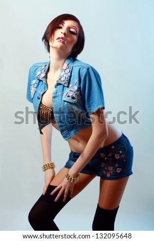 female high fashion model with art make up britain flag on her lips in jeans clothes
