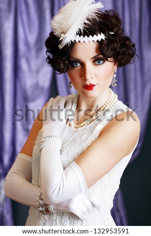 Beautiful young woman portrait in retro flapper style headband Vogue style vintage