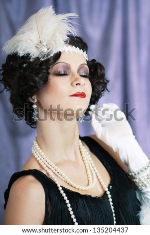 Beautiful young woman close up portrait in retro flapper style Vogue style vintage