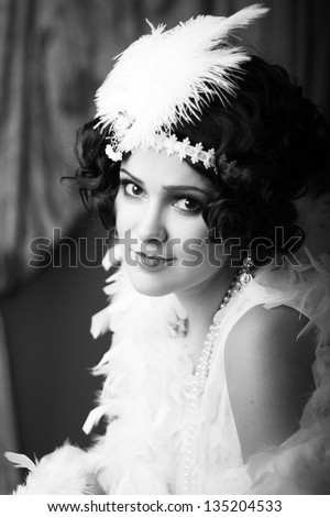 Beautiful young woman close up portrait in retro flapper style headband bw Vogue style vintage
