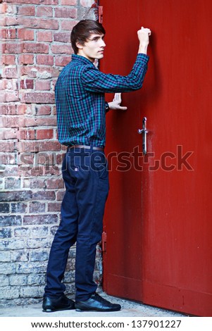 Businessman or student young man knocking on the door