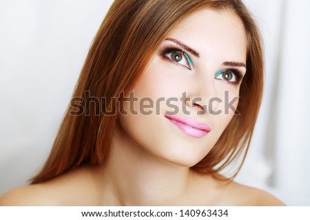 make-up woman close up face with bright make up looking down