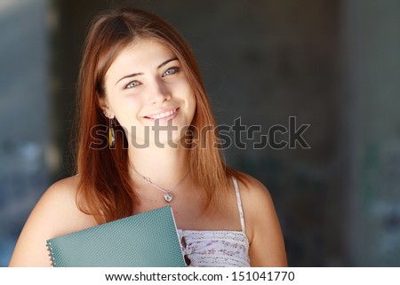 Student girl outside in summer park smiling happy. College or university student. Lot of copyspace