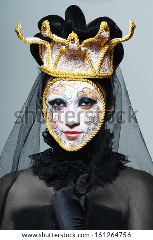 Beautiful woman with Venetian mask make up white and gold color with gold border and crown