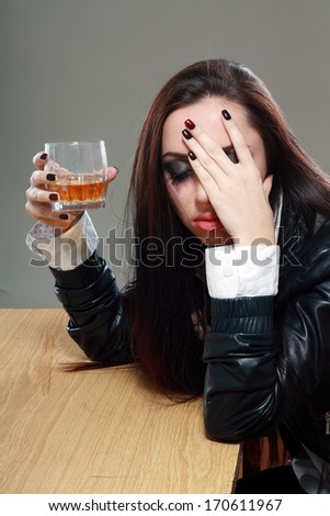 Young crying woman in depression drink drinking alcohol