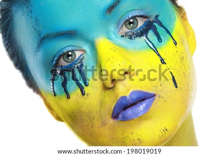 crazy color face art women portrait with yellow and blue as flag of Ukraine