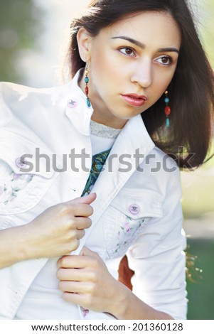 Fashion female model posing outdoors in sunny summer day. Fashion toning