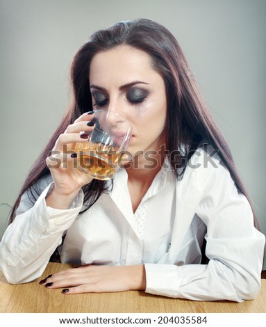Young crying woman in depression drink drinking alcohol