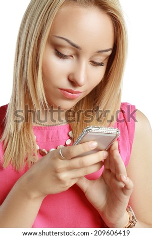 Beautiful blonde using mobile telephone or smartphone and smiles in doubt