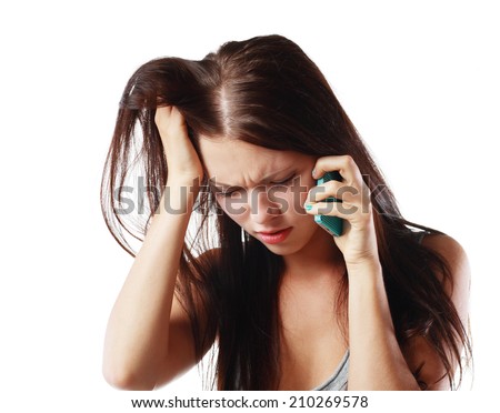 Closeup portrait, upset, sad, depressed, unhappy worried young woman talking on the phone, isolated white background. Negative human emotions, facial expressions, feelings, reaction. Bad news.